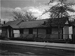 The O'Connor House was a long, narrow wood frame structure consisting of two sections with gable roofs and a small gable entry on Second Avenue façade.