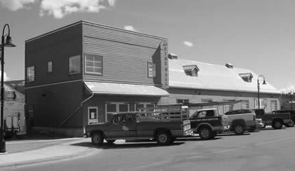 The Old Fire Hall building has a two-storey frame structure and a flat roof. As well it has two overhead doors and a concrete block foundation.
