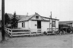 Palmer House is a wood frame house with a gable roof and shed entry at the front. It is set upon a wood sill foundation and has a roll asphalt roof.