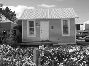 The Smith House is a wood frame structure has gable roofs constructed over a period of time. Galvanized steel roof decking and ship lap siding are also part of the building.