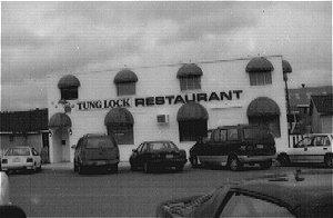 Originally, the Tung Lock restaurant was a one-storey wood frame structure with a gable roof. The exterior has a stucco finish.