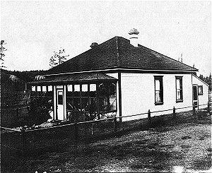 This house originally stood on Front Street behind the Whitehorse Hotel (near the corner of Main) when it was first built in 1901. The next year, it was moved by its owner E.A. Dixon from a site behind the White Horse Hotel to 306 Steele Street, where it sat until April 1979.