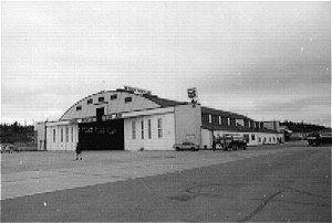 Hangar C is made from prefabricated wood frame and truss building components. An asphalt shingled dome roof covers the building and shed dormers.